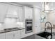 White cabinets, double oven, and gas cooktop in this kitchen at 6299 Crested Eagle Ln, Nokomis, FL 34275