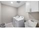 Bright laundry room with washer, dryer, and utility sink at 6299 Crested Eagle Ln, Nokomis, FL 34275