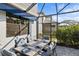 Screened-in patio with dining table and seating area at 6299 Crested Eagle Ln, Nokomis, FL 34275