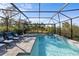 Screened pool and spa with lounge chairs; backyard view at 6299 Crested Eagle Ln, Nokomis, FL 34275