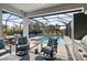 Relaxing pool area with covered patio, lounge chairs, and outdoor kitchen at 6299 Crested Eagle Ln, Nokomis, FL 34275