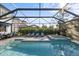 Enjoy this refreshing pool and spa with covered patio at 6299 Crested Eagle Ln, Nokomis, FL 34275