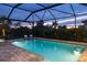 Inviting pool and spa area at dusk, under a screened enclosure at 6299 Crested Eagle Ln, Nokomis, FL 34275