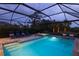 Screened pool and spa at night, with ambient lighting at 6299 Crested Eagle Ln, Nokomis, FL 34275