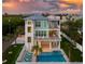 Elevated view of a two-story teal home with a pool and deck at 630 Companion Way, Longboat Key, FL 34228