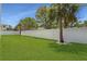 Spacious backyard with grassy lawn and white fence at 630 Companion Way, Longboat Key, FL 34228