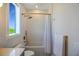 Modern bathroom with white wave tile, bathtub, and gold fixtures at 630 Companion Way, Longboat Key, FL 34228