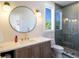 Modern bathroom with walk-in shower and large mirror at 630 Companion Way, Longboat Key, FL 34228