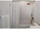 Clean bathroom with white wave tile, and tub shower combo at 630 Companion Way, Longboat Key, FL 34228