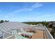 Spacious rooftop deck with lounge chairs, table and chairs, and a scenic view at 630 Companion Way, Longboat Key, FL 34228