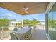 Covered deck with dining table and chairs at 630 Companion Way, Longboat Key, FL 34228