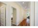 Light-filled hallway with wood floors and doors to bedrooms at 630 Companion Way, Longboat Key, FL 34228