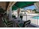 Relaxing poolside patio area with tables and chairs at 630 Companion Way, Longboat Key, FL 34228