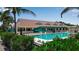 Resort-style pool with lounge chairs and a clubhouse at 630 Companion Way, Longboat Key, FL 34228