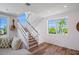 Modern staircase with white railings and hardwood floors at 630 Companion Way, Longboat Key, FL 34228