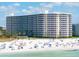 Aerial view of beachfront condo building with beach access at 6300 Midnight Pass Rd # 810, Sarasota, FL 34242