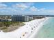 Aerial view of beachfront condo building with pool and beach access at 6300 Midnight Pass Rd # 810, Sarasota, FL 34242