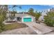 Charming single story home with teal garage door and well-manicured lawn at 633 Avenida De Mayo, Sarasota, FL 34242