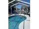 Inviting kidney-shaped pool with screened enclosure at 633 Avenida De Mayo, Sarasota, FL 34242