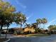 Community clubhouse entrance with palm trees and landscaping at 6442 Willowshire Way, Bradenton, FL 34212