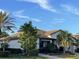 One-story house with tile roof, lush landscaping, and walkway at 6442 Willowshire Way, Bradenton, FL 34212