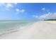 Scenic beach view with white sand and calm ocean at 655 Longboat Club Rd # 14A, Longboat Key, FL 34228