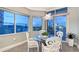 Bright breakfast nook with a glass table and ocean views at 655 Longboat Club Rd # 14A, Longboat Key, FL 34228