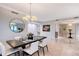 Elegant dining room with a modern table, chandelier, and large windows at 655 Longboat Club Rd # 14A, Longboat Key, FL 34228