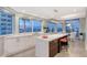 Modern kitchen with island, white cabinets, and ocean views at 655 Longboat Club Rd # 14A, Longboat Key, FL 34228