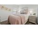 Cozy bedroom with a blush-colored comforter and nightstand at 6708 162Nd E Pl, Parrish, FL 34219