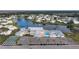 Aerial view of community with lake, pool, and shuffleboard at 680 Circlewood Dr # W3, Venice, FL 34293