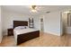 Bedroom with ceiling fan, wood flooring, and access to bathroom at 680 Circlewood Dr # W3, Venice, FL 34293