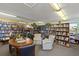 Community library with ample seating and bookshelves at 680 Circlewood Dr # W3, Venice, FL 34293