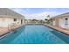 Community pool with surrounding lounge chairs at 680 Circlewood Dr # W3, Venice, FL 34293