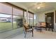 Relaxing sunroom with wicker furniture and view of backyard at 680 Circlewood Dr # W3, Venice, FL 34293