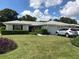 Single-story home with a well-maintained lawn and attached garage at 7092 W Country Club N Dr, Sarasota, FL 34243