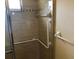 Accessible shower with grab bars and tiled walls at 7092 W Country Club N Dr, Sarasota, FL 34243