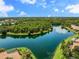 Aerial view showcases community lake and lush green landscape at 790 Shadow Bay Way, Osprey, FL 34229