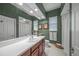 Clean and bright guest bathroom with single vanity and shower/tub combo at 790 Shadow Bay Way, Osprey, FL 34229