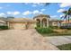 Front view of a stunning house with a large driveway and lush landscaping at 790 Shadow Bay Way, Osprey, FL 34229