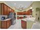 Spacious kitchen with stainless steel appliances and light wood cabinets at 790 Shadow Bay Way, Osprey, FL 34229