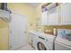 Laundry room with washer, dryer, and utility sink at 790 Shadow Bay Way, Osprey, FL 34229