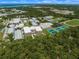 Aerial view of a school with sports fields and tennis courts at 790 Shadow Bay Way, Osprey, FL 34229