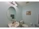 Clean bathroom with an oval mirror, light blue walls, and a neutral color scheme at 8108 Haven Harbour Way, Bradenton, FL 34212