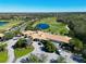 Aerial view of community clubhouse with golf course and pond at 8108 Haven Harbour Way, Bradenton, FL 34212