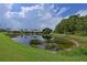 Serene community lake with lush greenery and homes reflected in the water at 8108 Haven Harbour Way, Bradenton, FL 34212