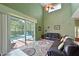 Comfortable living room featuring a high ceiling, leather furniture and pool view at 8108 Haven Harbour Way, Bradenton, FL 34212