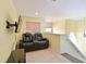 Upstairs loft area with a black leather recliner sofa and TV at 8108 Haven Harbour Way, Bradenton, FL 34212