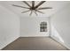 Spacious bedroom featuring grey carpet and a ceiling fan at 8932 Manor Loop # 207, Lakewood Ranch, FL 34202