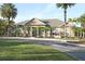 Community clubhouse with palm trees and landscaping at 8932 Manor Loop # 207, Lakewood Ranch, FL 34202